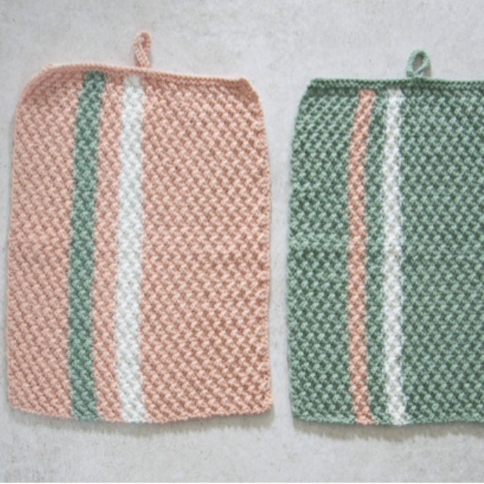 Knitted hand towel and face washers set with striped patterns in pastel colors, made using moss stitch and rib stitch techniques.