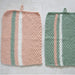 Knitted hand towel and face washers set with striped patterns in pastel colors, made using moss stitch and rib stitch techniques.
