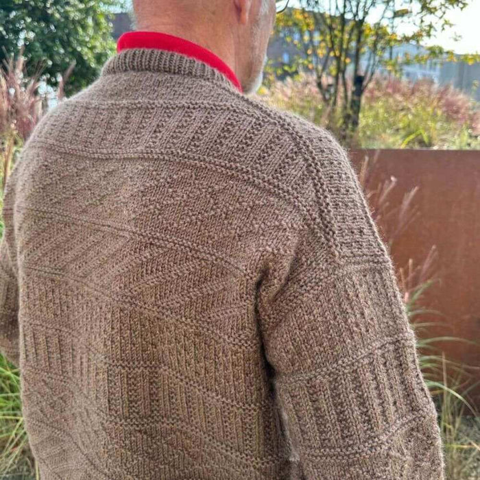 PetiteKnit Storm Sweater Man in textured brown knit pattern, outdoor setting.