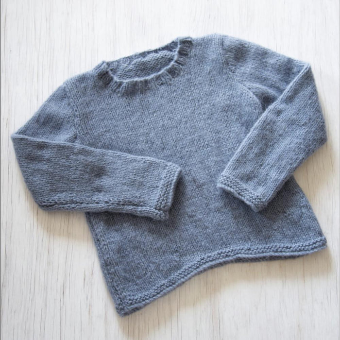 Knitted gray sweater with shaped lower edge in Chaska Alpaca Air yarn.