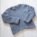 Knitted gray sweater with shaped lower edge in Chaska Alpaca Air yarn.