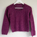 Knitted lace sweater with intricate pattern on hanger; DK/8ply yarn; vibrant purple tone.
