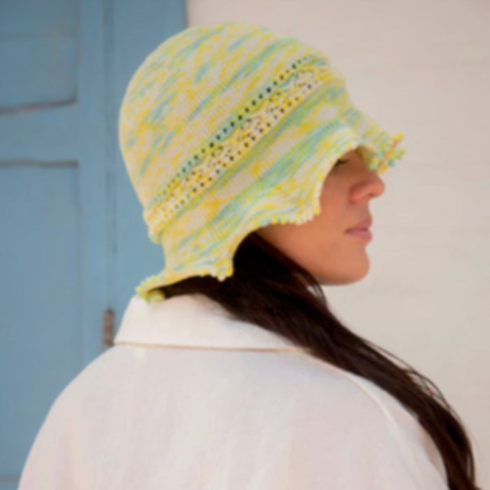 Intermediate Vega Hat knitting pattern with decorative band and ruffled brim using Amano Inti yarn.