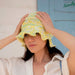Vega Hat Knitting Pattern in Amano Inti yarn with decorative band and ruffled brim.
