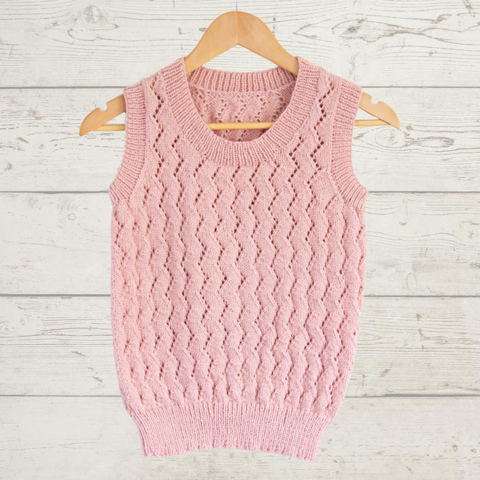 Vest with all-over lace knitting pattern in pink, featuring ribbed edges and scoop neckline on hanger.