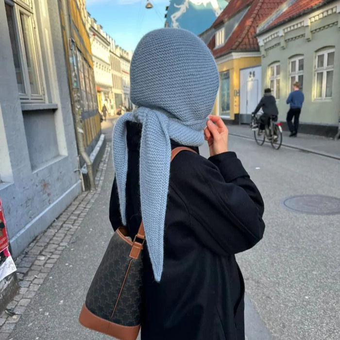 Cozy blue hooded scarf worn outdoors on a street.