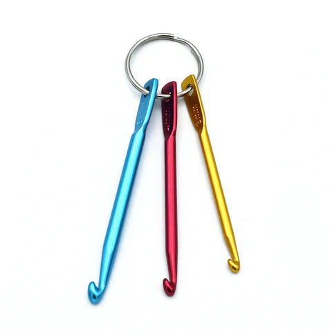 Set of 3 colorful aluminum crochet hooks on a split ring for knitting repair, sizes 3mm, 4mm, and 5mm.