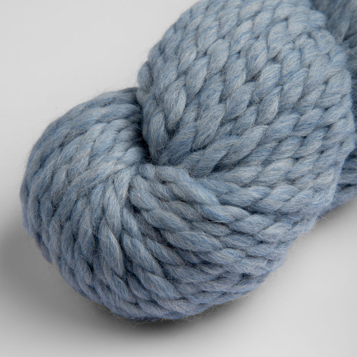Chunky blue skein of Amano Mamacha yarn made of baby alpaca and merino wool.