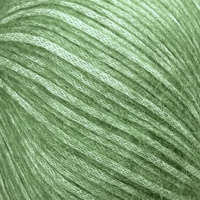 Green yarn ball used in Simple Triangle Shawl Knit Kit, featuring soft and lightweight blow yarn.