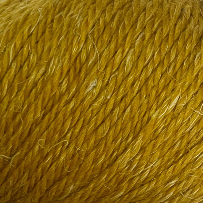 Luxurious 12-ply yarn blend of superfine alpaca, wool, and hemp with a textured, tweedy appearance.