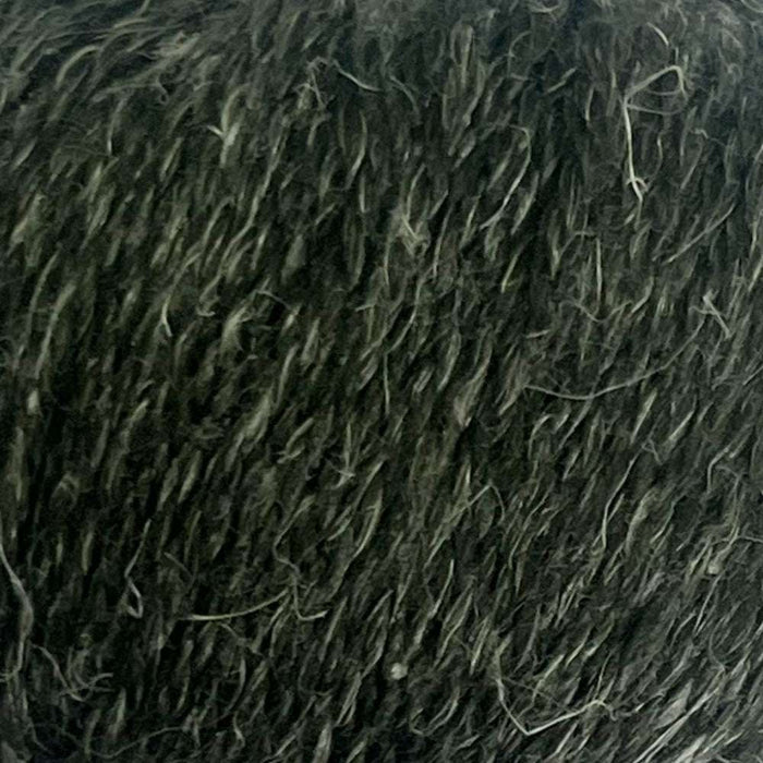 Luxurious 12-ply yarn with a natural, tweedy texture in dark hue, perfect for cozy knit projects.