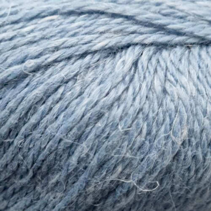 12-ply blue yarn with alpaca, wool, and hemp blend for cozy, textured knitting projects.