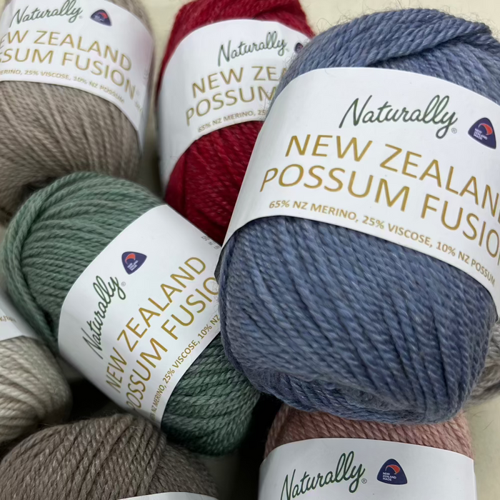 Cabled Beanie Knit Kit with Naturally New Zealand Possum Fusion yarn balls in assorted colors.