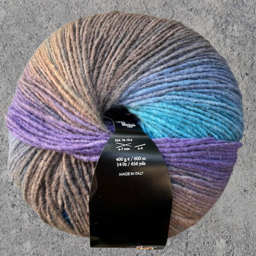 Sesia Maxxi Merino wool yarn ball in multicolor shades, ideal for cozy knitting projects.