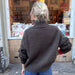 Woman wearing an oversized Hannah Sweater O-neck knitted from the top down in stockinette stitch