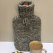 Hand-knitted Hot Stuff hot water bottle cover in marled 10 ply yarn