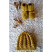 Flat lay of the golden cabled baby hat and button-tab boots — Vita Hat and Boots, Lisa F BC141.