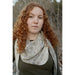 Model wearing a pale asymmetrical knitted shawl — Arlet Shawl, Lisa F HC57.