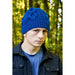 Model wearing a bright blue chunky cable hat — Henley Hat, Lisa F HC67.
