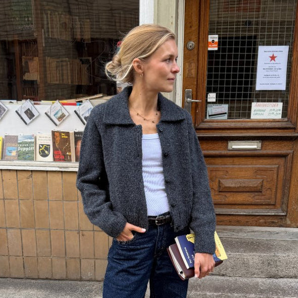 Petra Jacket Knitting Pattern featuring a dark charcoal knitted jacket with a relaxed fit and notched collar
