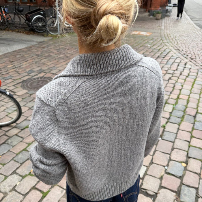 Petra Jacket Knitting Pattern, grey knitted jacket in smooth stocking stitch with ribbed collar and cuffs, back view
