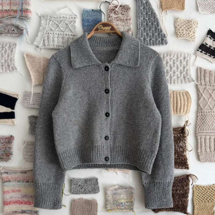 Petra Jacket Knitting Pattern, a grey knitted jacket with collar, button front and ribbed cuffs and hem